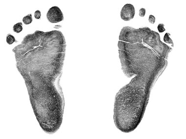 Two dark grey footprints on a white background.