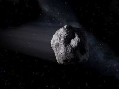Large asteroid in front of a black, starry background.