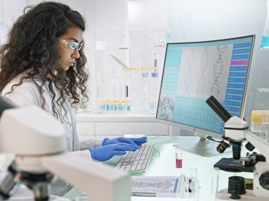 Female Scientist typing on a computer.jpg