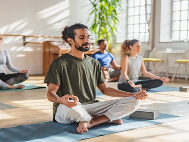 man sitting with crossed legs while meditating.jpg