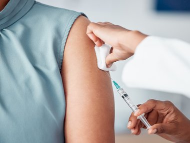 medical provider administering a vaccine into a patients arm.jpg