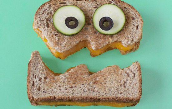 grilled cheese sandwich cut in half in the shape of a face
