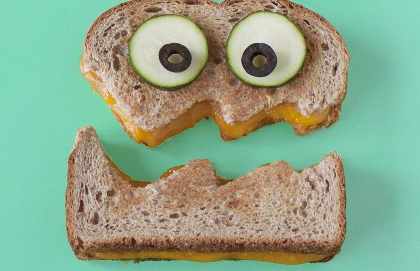 grilled cheese sandwich cut in half in the shape of a face