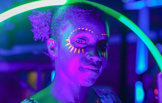 Guest enjoying black light activities at the Glow event