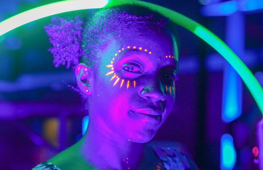 Guest enjoying black light activities at the Glow event