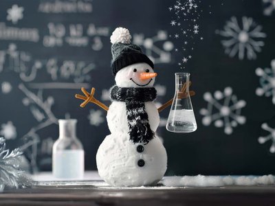 festive snowman holding a glass beaker.jpg