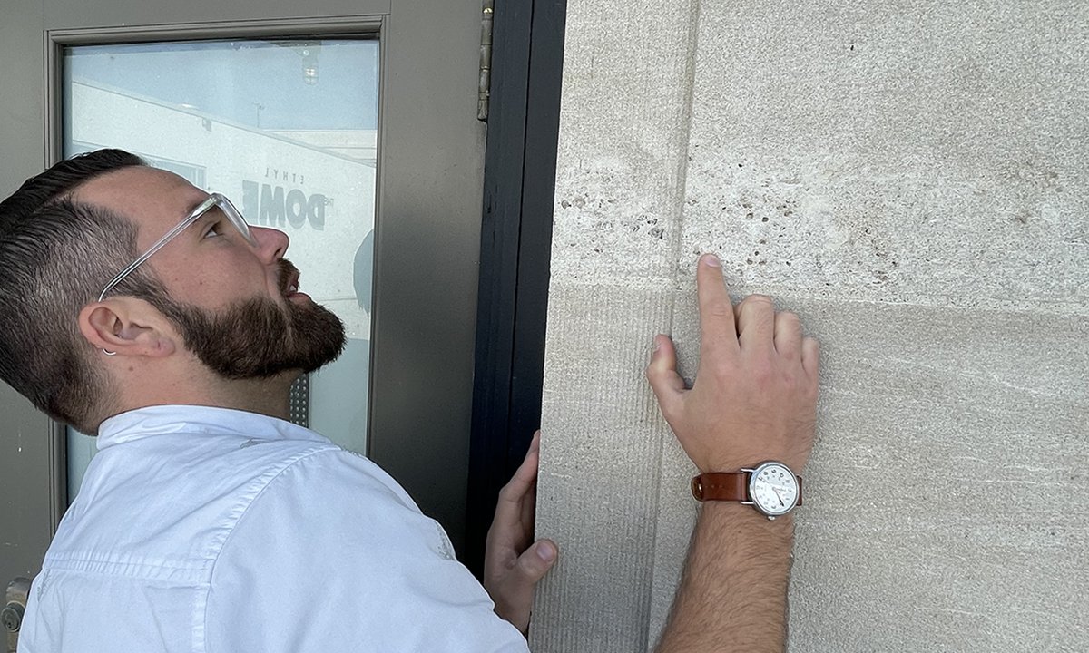 Dr. Jeremy Hoffman looking at a wall on the Science Museum's building.