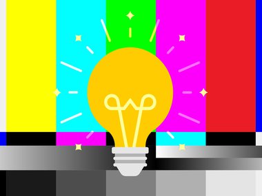 Shinning light bulb illustration with an old block multi-colored background mixed with black and white