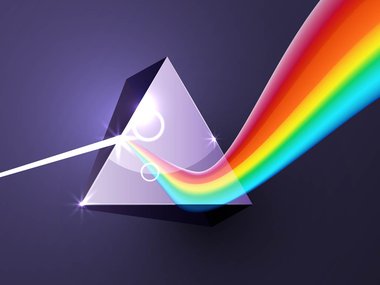 Illustration of a prism on a purple background. Light shines through the prism emitting a rainbow effect.