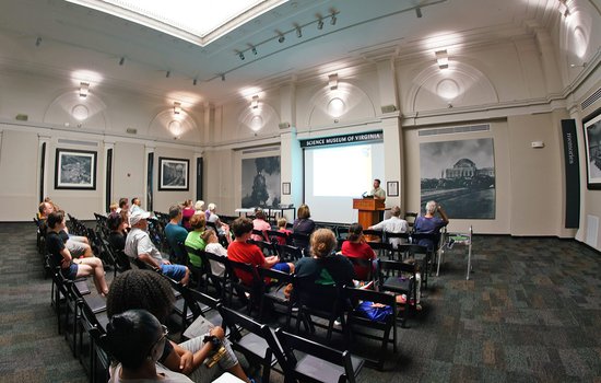 Image of a group watching a lecture in the RF&P Forum