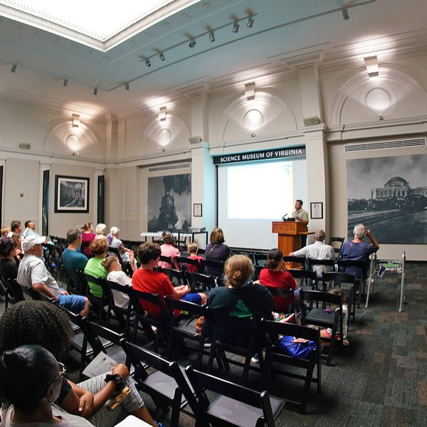Image of a group watching a lecture in the RF&P Forum