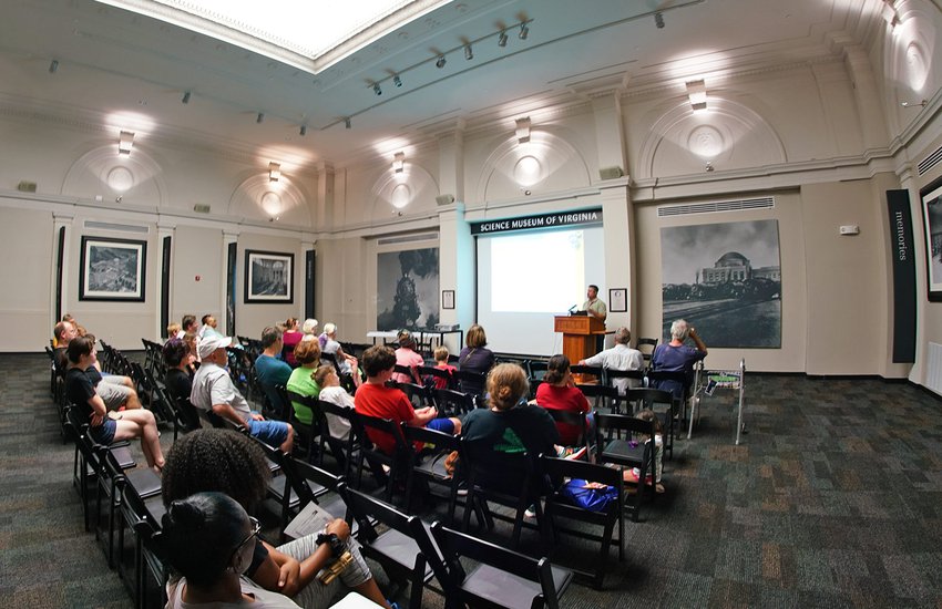Image of a group watching a lecture in the RF&P Forum