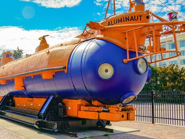 Image of orange and blue Aluminaut submarine on a sunny day