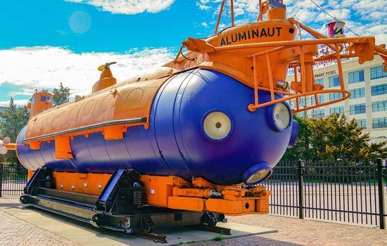 Image of orange and blue Aluminaut submarine on a sunny day