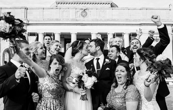 Image of wedding party out front of the Science Museum by Kimie James