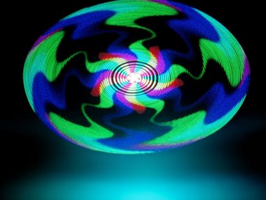 decorative psychedelic swirling pattern of green, blue, yellow and magenta