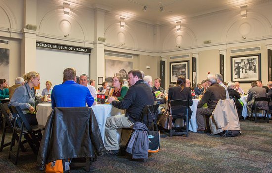 Group sits at table during luncheon in the RF&P Forum