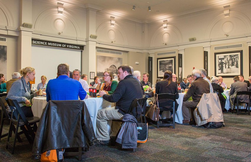 Group sits at table during luncheon in the RF&P Forum