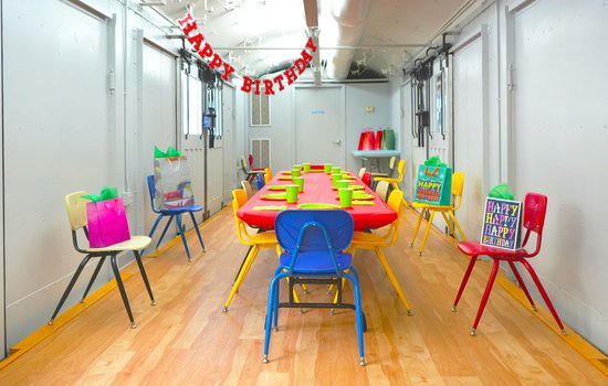 Photograph of bright colored gifts birthday banner and decor in WonderPlace at the Science Museum of Virginia