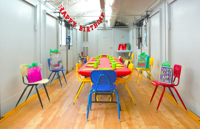 Photograph of bright colored gifts birthday banner and decor in WonderPlace at the Science Museum of Virginia