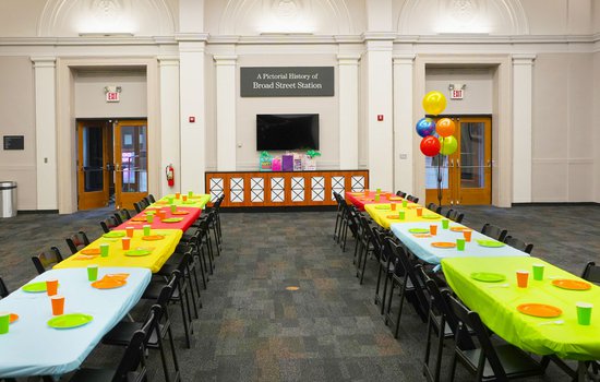 Photograph of the RF&P Forum doors with bright colored table decorations and birthday decor for birthday parties