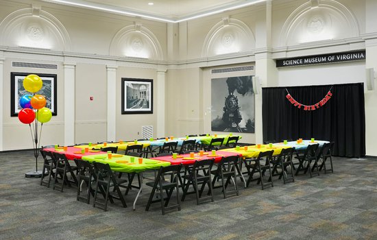 Photograph of the RF&P Forum setup with bright colored table decorations and birthday decor for a birthday party