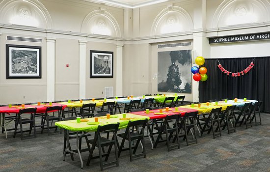 Photograph of the RF&P Forum with tables bright colored decorations and birthday decor for a birthday party