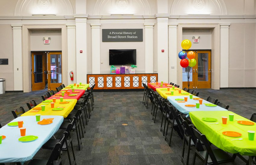 Photograph of the RF&P Forum doors with bright colored table decorations and birthday decor for birthday parties