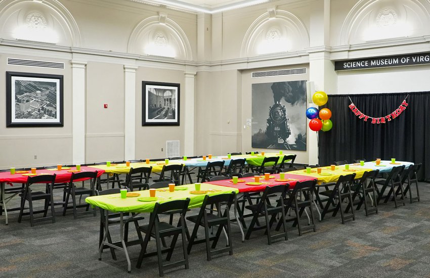 Photograph of the RF&P Forum with tables bright colored decorations and birthday decor for a birthday party