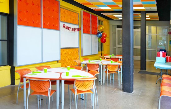 Photography of bright orange chairs and birthday gifts in the Challenge Lab