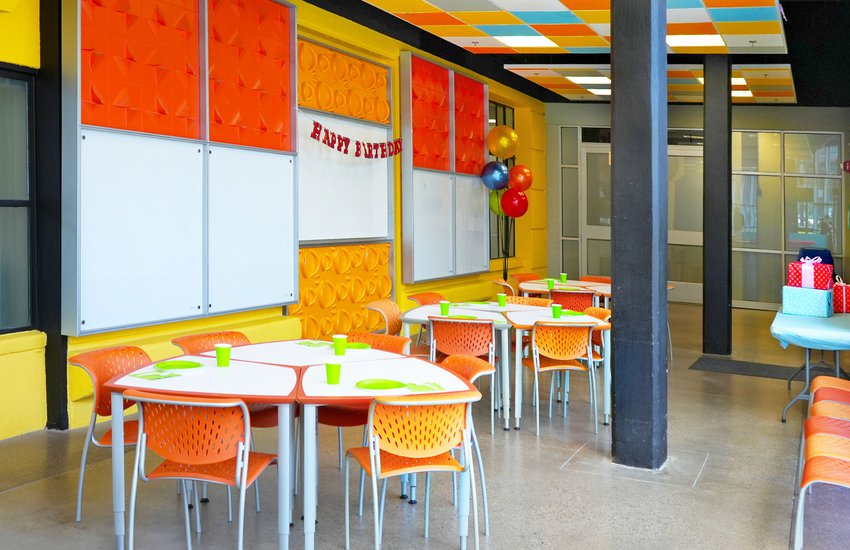 Photography of bright orange chairs and birthday gifts in the Challenge Lab