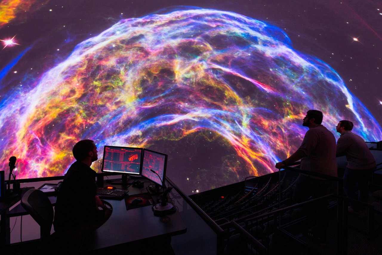 Pink, purple, orange, and blue colored space image in The Dome.