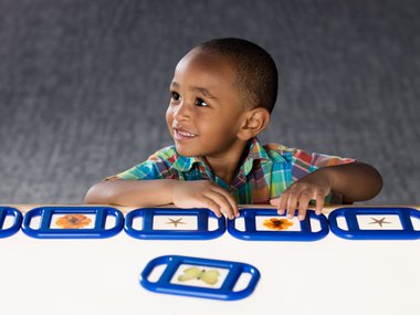 Child observing plants and insects in LightPlace.
