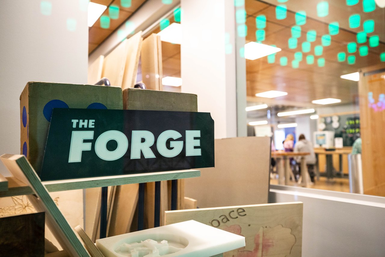 Black sign with the words "The Forge" written in white letters.