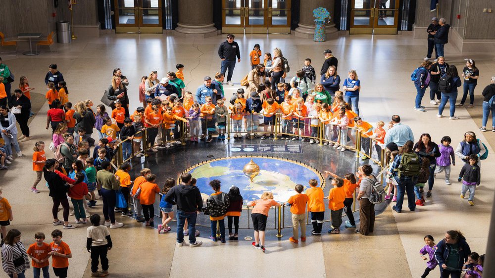 group of students observing the Foucault Pendulum.jpg