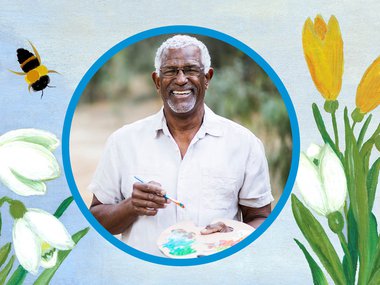 Black male senior holding a paint brush and palette