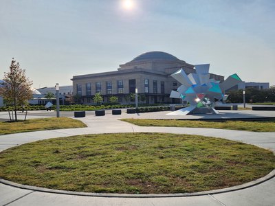 Sun rising over the Science Museum of Virginia building and the Cosmic Perception sculpture.jpg