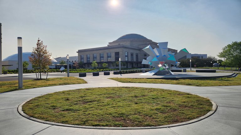 Sun rising over the Science Museum of Virginia building and the Cosmic Perception sculpture.jpg