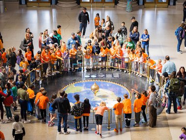 Group of students surrounding the Foucault Pendulum in the Rotunda .jpg