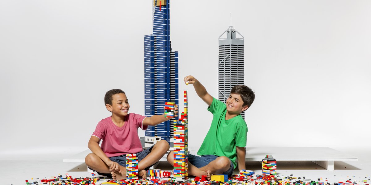 Two boys sitting on the floor building a tower with Lego Bricks.jpg