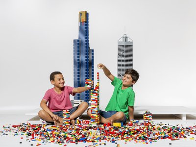 Two boys sitting on the floor building a tower with Lego Bricks.jpg