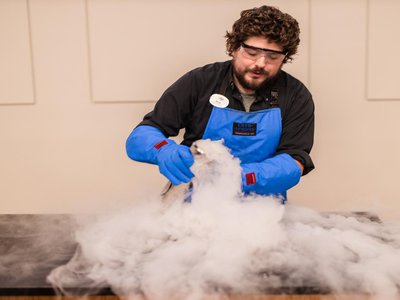educator demonstrating chemical reaction.jpg