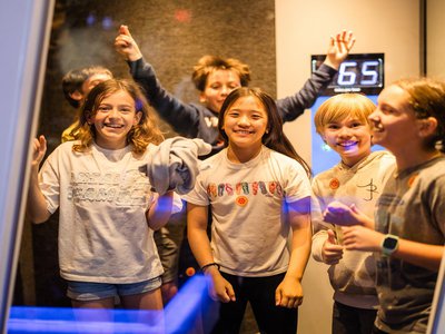 Group of school age children enjoying an exhibit