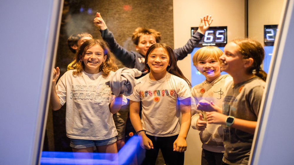 Group of school age children enjoying an exhibit