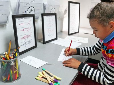 A child drawing in the Art Lab.