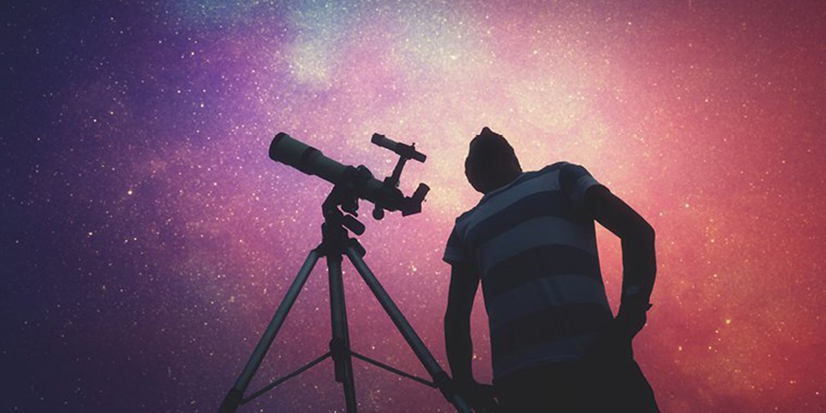 A person with a telescope looking at stars.