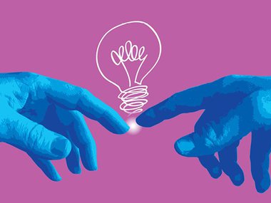 A lightbulb steaming from two blue hands touching.