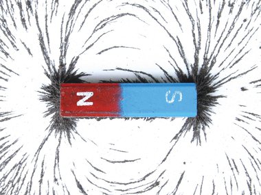 Magnets with iron shavings creating a magnetic field.