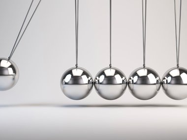 Silver balls of a cat's cradle to display force and motion.