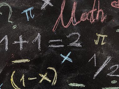 Math and symbols on a blackboard.